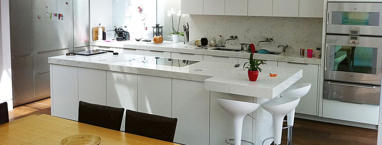 White kitchen with a central island from Mercury’s project portfolio